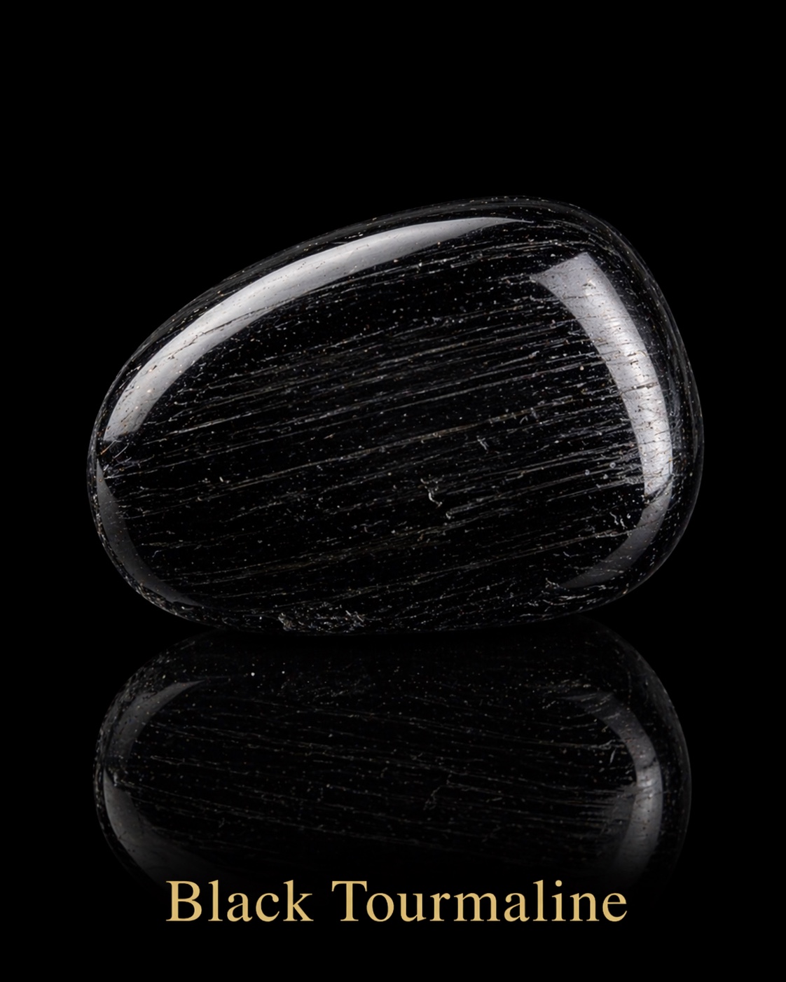 Polished black tourmaline with pale lines and white reflections against black
