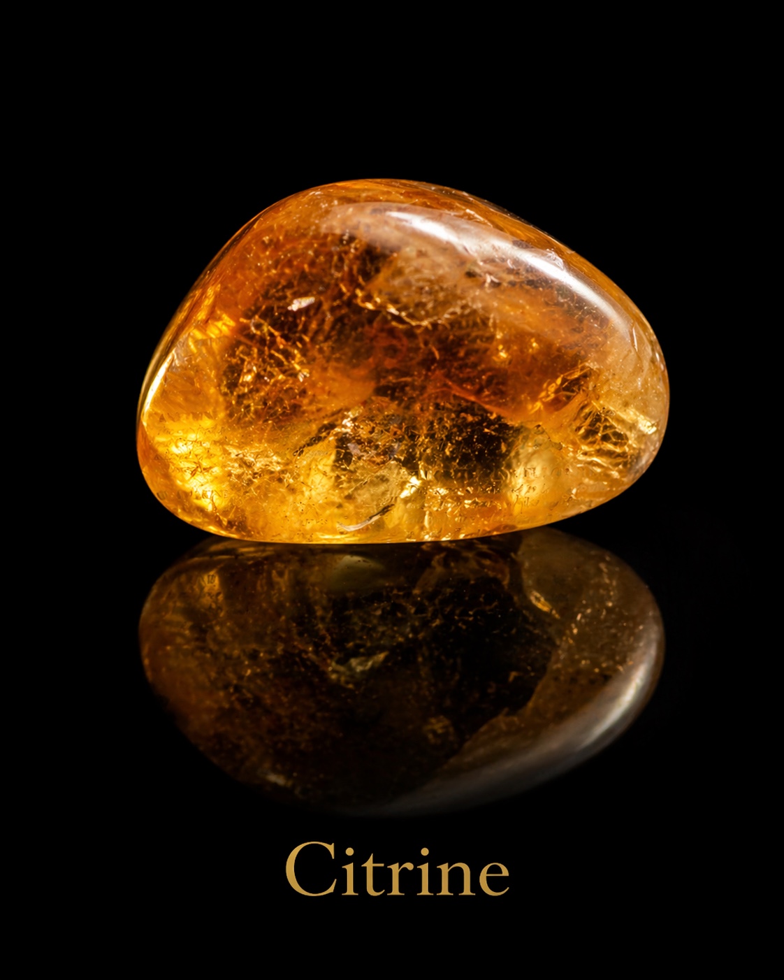 Golden yellow citrine with intricate bright interior textures reflected against black